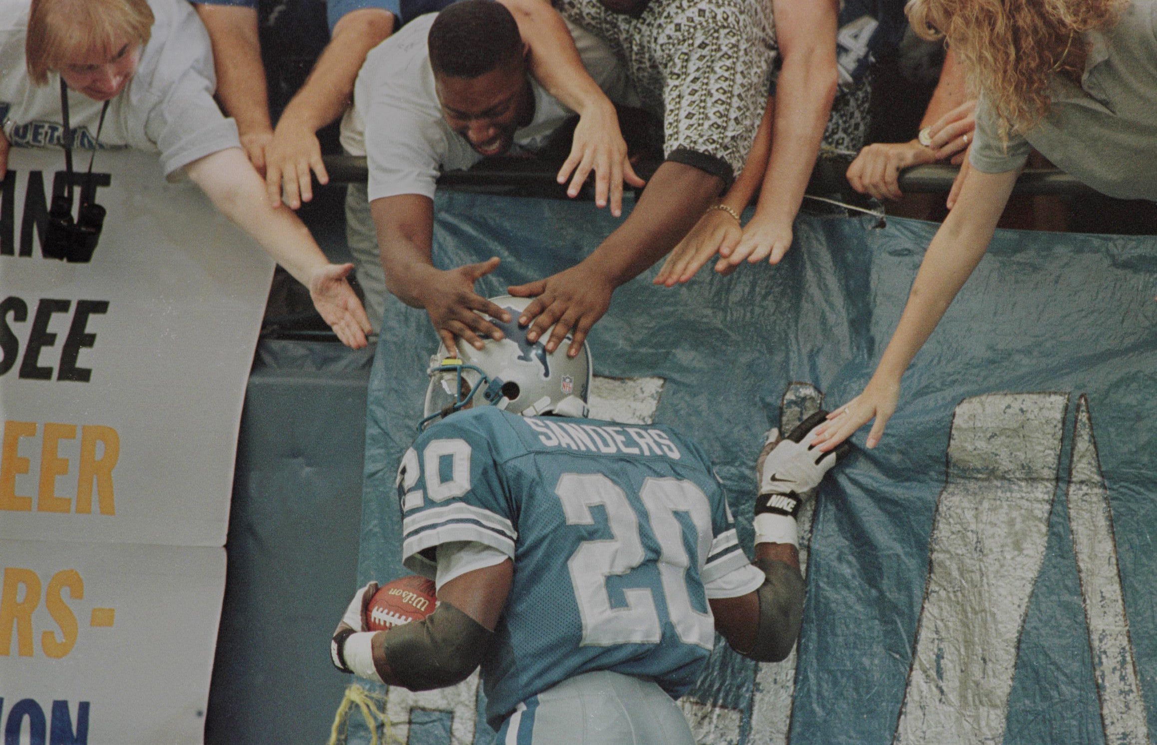 Barry Sanders celebrates with fans after a touchdown against the Tampa Bay Buccaneers in Detroit on Sept. 9, 1996.