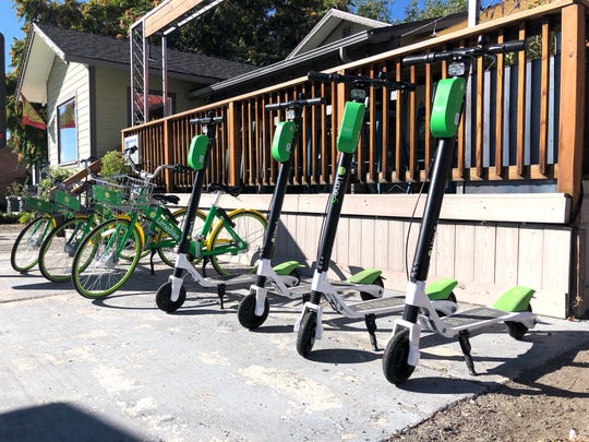 Lime scooters and lime bikes parked outside the Sup Restaurant in Midtown on the morning of September 18, 2018.