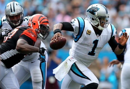 Carolina Panthers quarterback Cam Newton (1) escapes pressure from Cincinnati Bengals defensive tackle Geno Atkins (97) in the fourth quarter during a Week 3 NFL game between the Cincinnati Bengals and the Carolina Panthers, Sunday, Sept. 23, 2018, at Bank of America Stadium in Charlotte, North Carolina. Carolina won 31-21. 