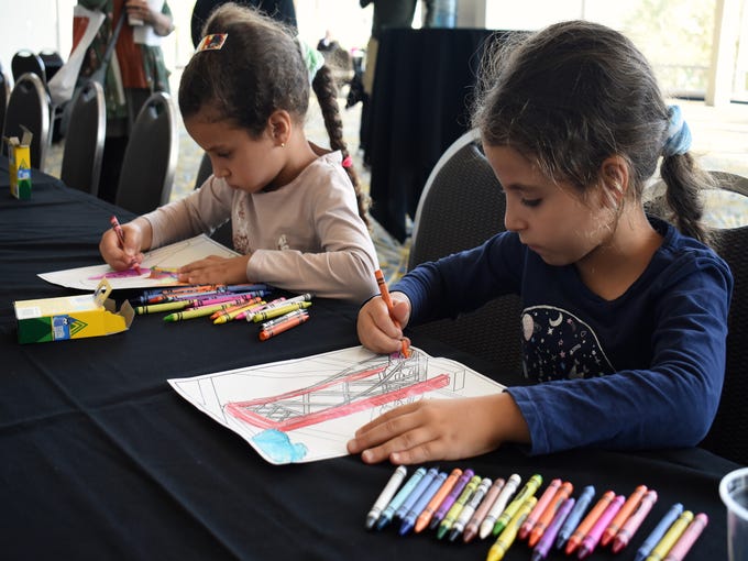 Sisters Jowayreya, 5, left, and Taleen, 7, Garamoon, of Sterling Heights, add their own colors to drawings of the fresco details.