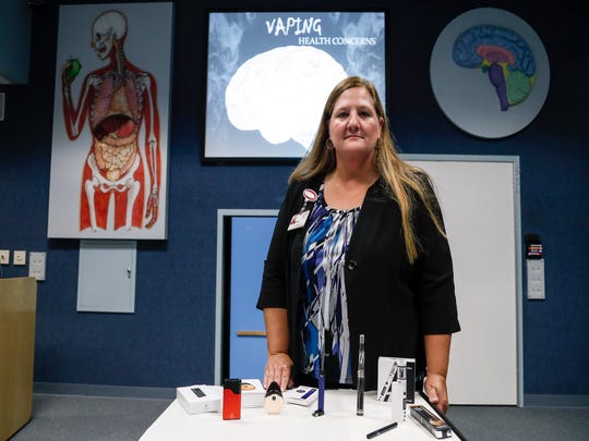 Cheryl Phillps, coordinator of the St. Joseph Mercy Health Exploration Station, shows an exhibition of popular vaping products that she uses for her presentation on the health issues associated with vaping.