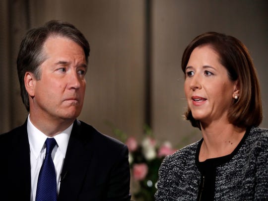 Brett Kavanaugh, left, looks at wife Ashley Estes Kavanaugh as they answer questions during a Fox News interview Sept. 24, 2018, in Washington.