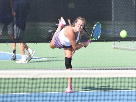 Wylie's Hailey Parker follows through on a serve during her girls doubles match with Rebecca Yates against Aledo on Monday, Sept. 24, 2018. The Bulldogs won 12-7.