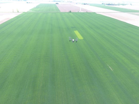 A drone flies over a farm field in the Thumb.