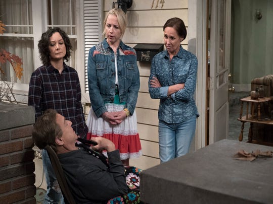 Darlene (Sara Gilbert), standing left, Becky (Lecy Goranson) and Jackie (Laurie Metcalf) stand in front of Dan (John Goodman), left, in "The Conners" of ABC.