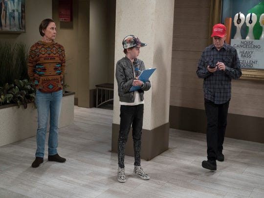 Trump's pro-Roseanne may have left, but "The Conners" will still address contemporary politics, as in an upcoming episode where young Mark (Ames McNamara), in the center, conducts an election poll, as Jackie observes (Laurie Metcalf).