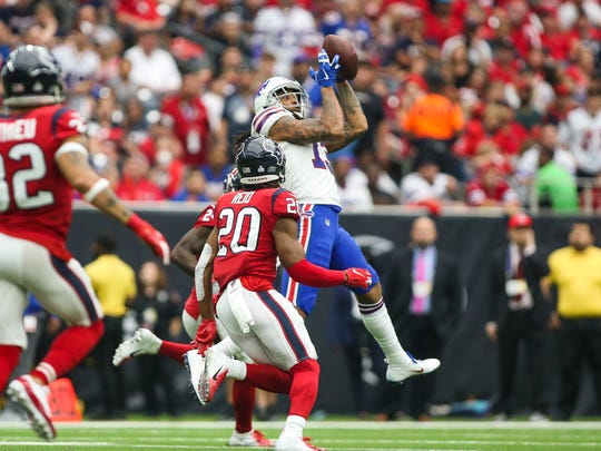 October 14, 2018; Houston, TX, USA; Buffalo Bills receiver Kelvin Benjamin (13) receives defenseman Justin Reid (20), a Houston Texans defenseman, in the third quarter at NRG Stadium. Mandatory Credit: Troy Taormina-USA TODAY Sports