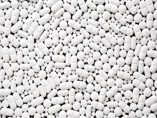 Top view of white pills on black background