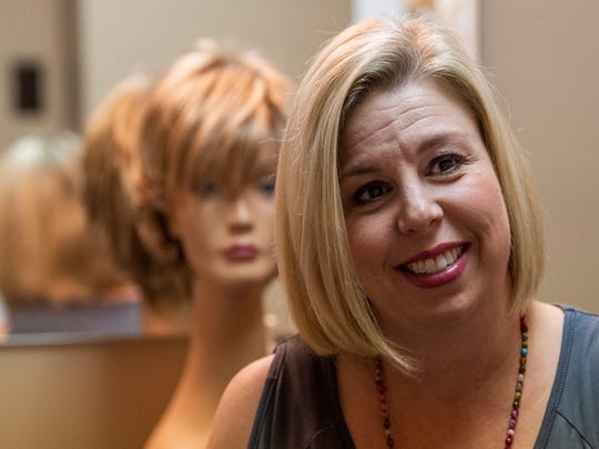 Tisha Ward works with wigs for cancer patients as part of her work at the American Cancer Society in Montgomery, Alabama, on Tuesday, October 16, 2018.