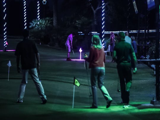 Projectors project different putting games on practice greens at Indian Wells Golf Resort on Wednesday, October 17, 2018 during "Shot in the Night."