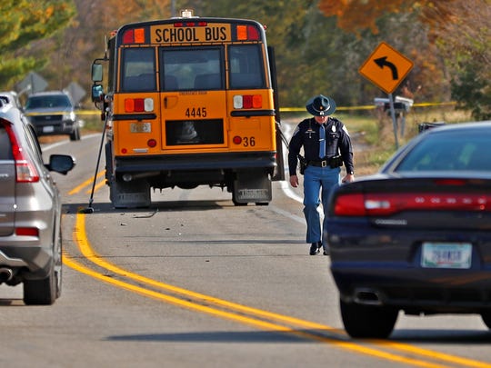 The scene is investigated on State Rd. 25 in Rochester, IN, where a pickup truck hit and killed three young children and critically injured on the road to get on this school bus, Tuesday, Oct. 30, 2018. The bus was stopped with lights and stop indicators in use.