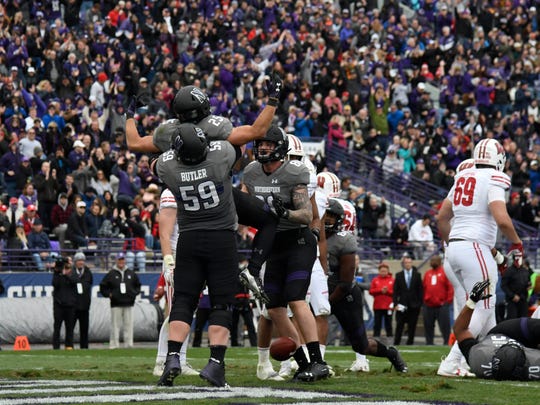 Halfback Isaiah Bowser celebrates with his teammates after his touchdown against Wisconsin.