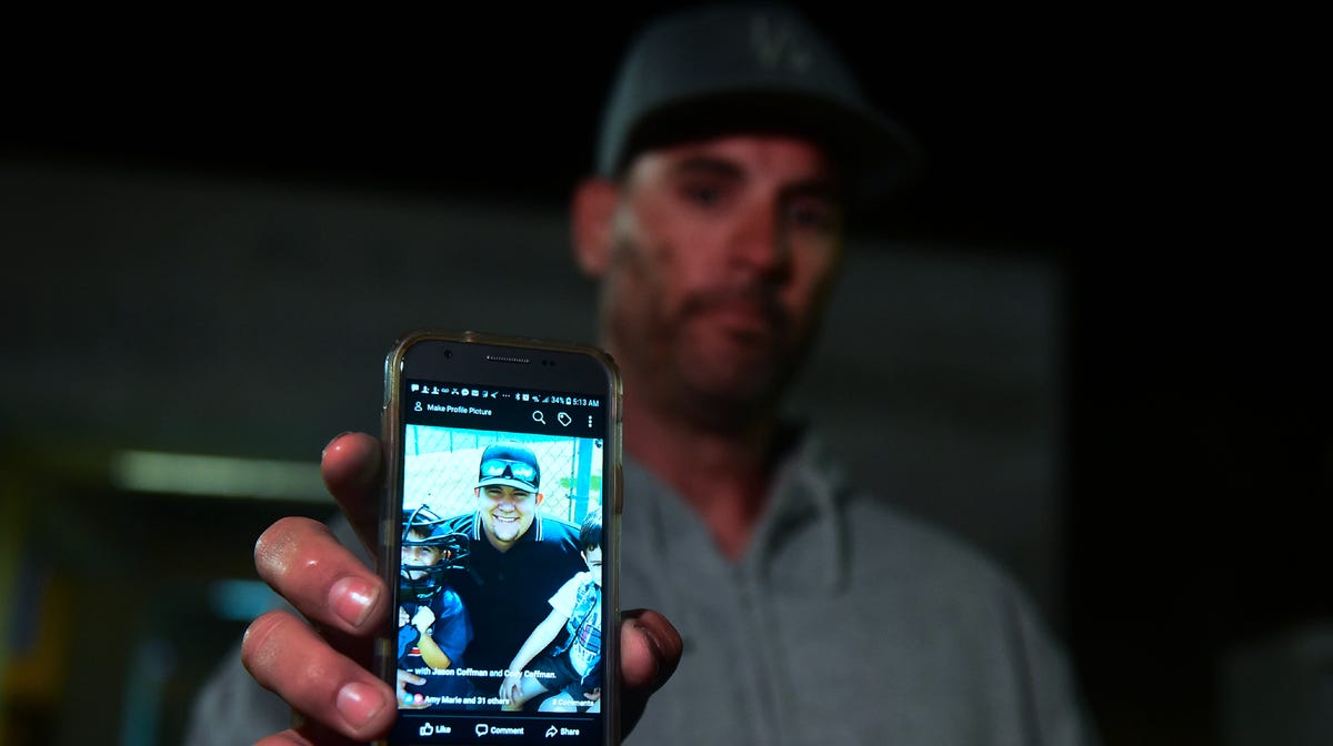 Jason Coffman displays a photo of his son Cody outside the Thousands Oaks Teen Center. He came there hoping to find Cody, who was at the Borderline Bar and Grill in Thousand Oaks, Calif., on Nov. 8, 2018.