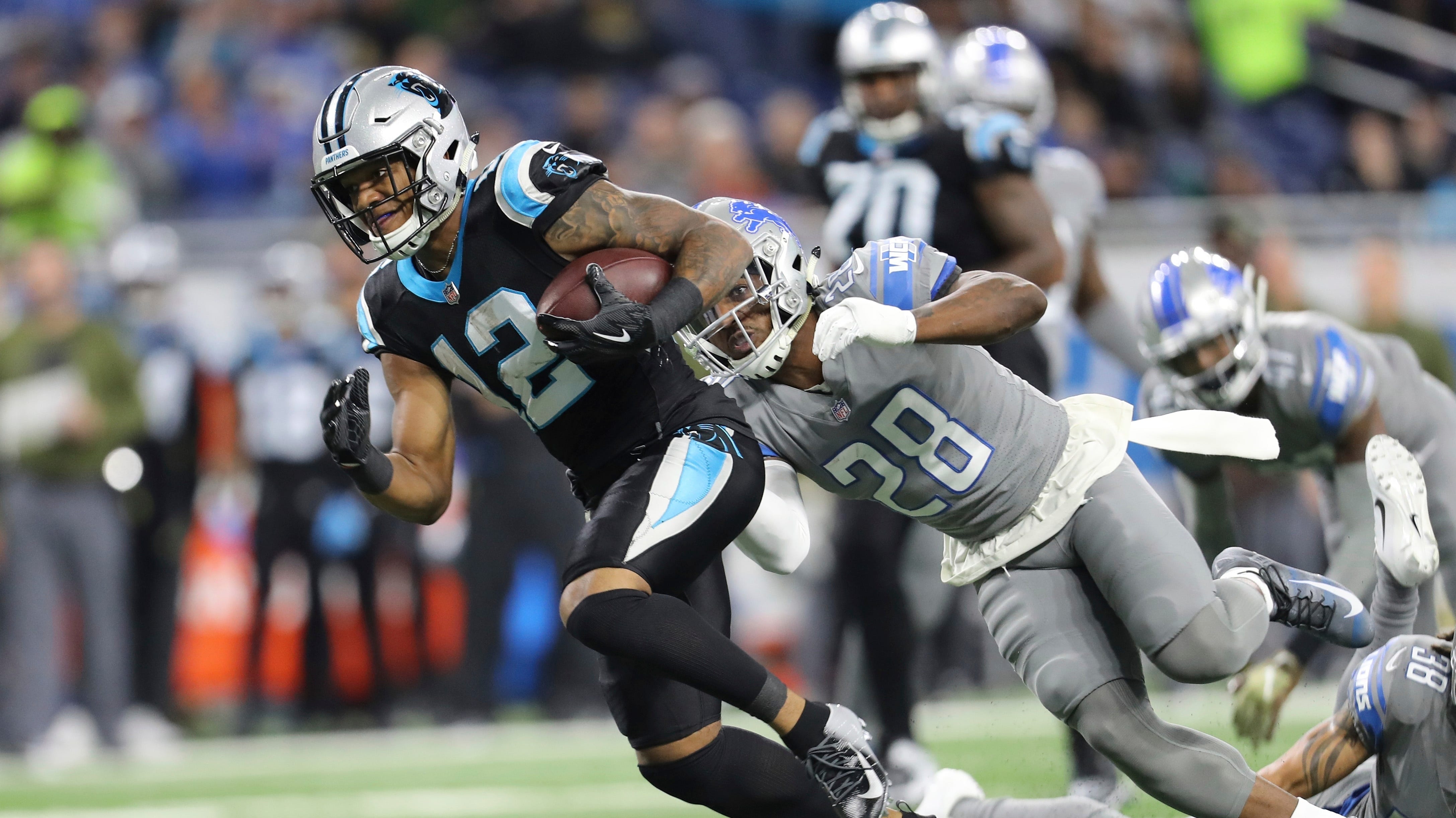 Carolina Panthers wide receiver DJ Moore is chased by Detroit Lions strong safety Quandre Diggs during the first quarter.