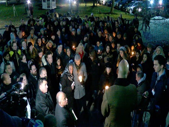 People gather in front of the Colts Neck Town Hall on Wednesday evening November 21, 2018, for a vigil in memory of the Caneiro family killed in the fire of a house the night before.