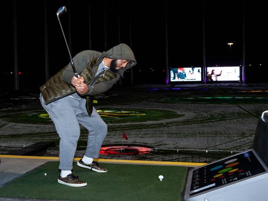 Detroit Pistons center Andre Drummond takes a swing at the new Topgolf in Auburn Hills on Wednesday, Nov. 28, 2018.