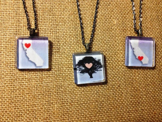 The “Love for California” collection consists of three pendants, from left: one with a heart in Northern California where the Camp Fire destroyed the small town of Paradise, one featuring a city of Thousand Oaks tree with a heart in the center and one depicting the state of California with a heart in the location of the Woolsey and Hill Fires. This collection was created by Nancy Kanter, owner of Sparkling Vine Design in Newbury Park, and 100 percent of profits go to victims of the shooting at Borderline Bar & Grill in Thousand Oaks and fire victims.