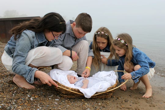 Mia, Adam, Beth and Hannah Stromberg with their foster brother at Lighthouse Park beach in Port Huron. The baby arrived at their home on April 18, 2015 and this photo was taken a short while later.