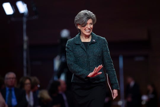 Sen. Joni Ernst finds her seat before Gov. Kim Reynolds' Inauguration ceremony on Friday, Jan. 18, 2019, in Des Moines. 