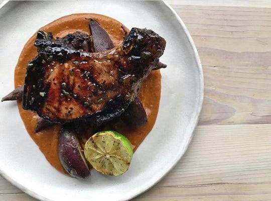 Pelican & Pig offers pork chops with winter root and squash mole, white sweet potato and grilled citrus.