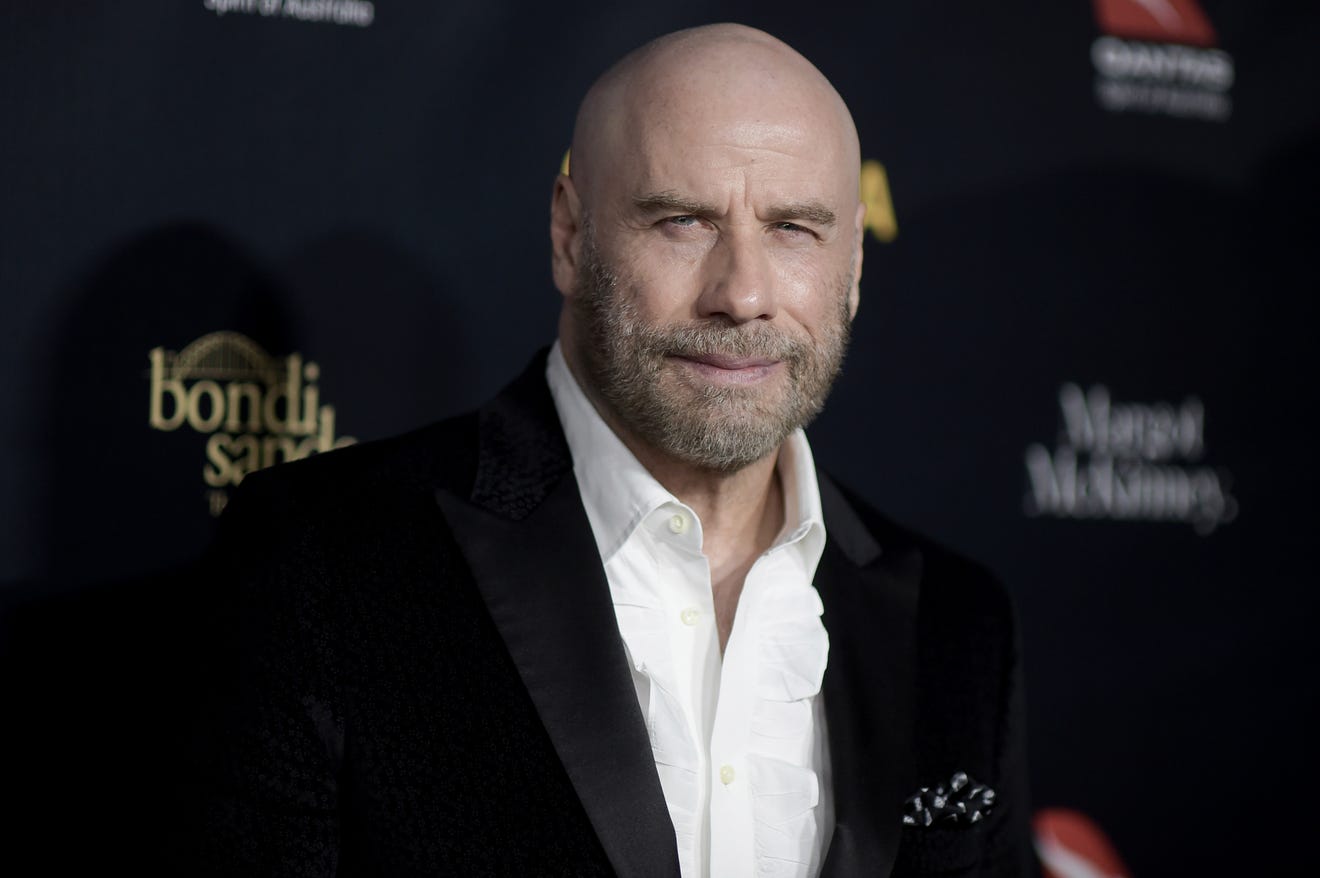 John Travolta is keeping the cool, bald look and it 'feels great'