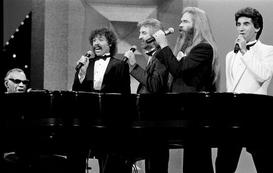 The Oak Ridge Boys were joined by Ray Charles at the piano during a 1984 appearance at the CMA Awards. Joe Bonsall (from left), Duane Allen, William Lee Golden and Richard Sterban form the Oaks.