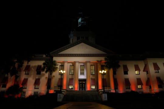 The Florida Historic Capitol Museum is lit with orange lights Tuesday, Feb. 12, 2019, in honor of the victims of the Feb. 14, 2018 Marjory Stoneman Douglas High School shooting.