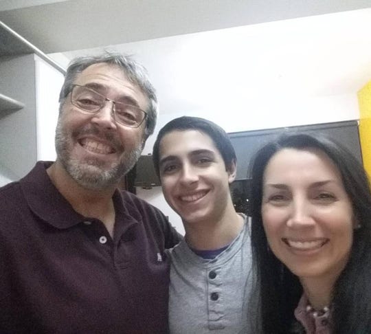 Daniel Di Martino, center, with his parents in Caracas, Venezuela, in December 2016.