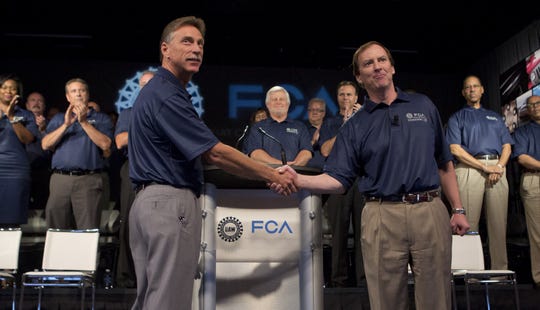 UAW Vice President Norwood Jewell, left, and Fiat Chrysler Vice President Glenn Shagena shake hands during the ceremonial start of contract negotiations in 2015.