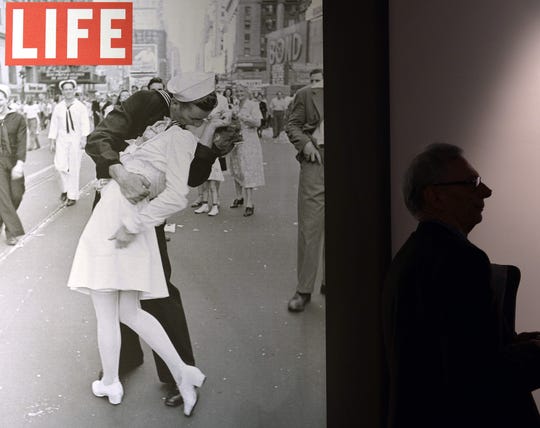 A visitor walks past "VJ Day in Times Square, New York, NY, 1945" by Alfred Eisenstaedt during the "Life I grandi fotografi", (The great photographers) exhibition in Rome. 