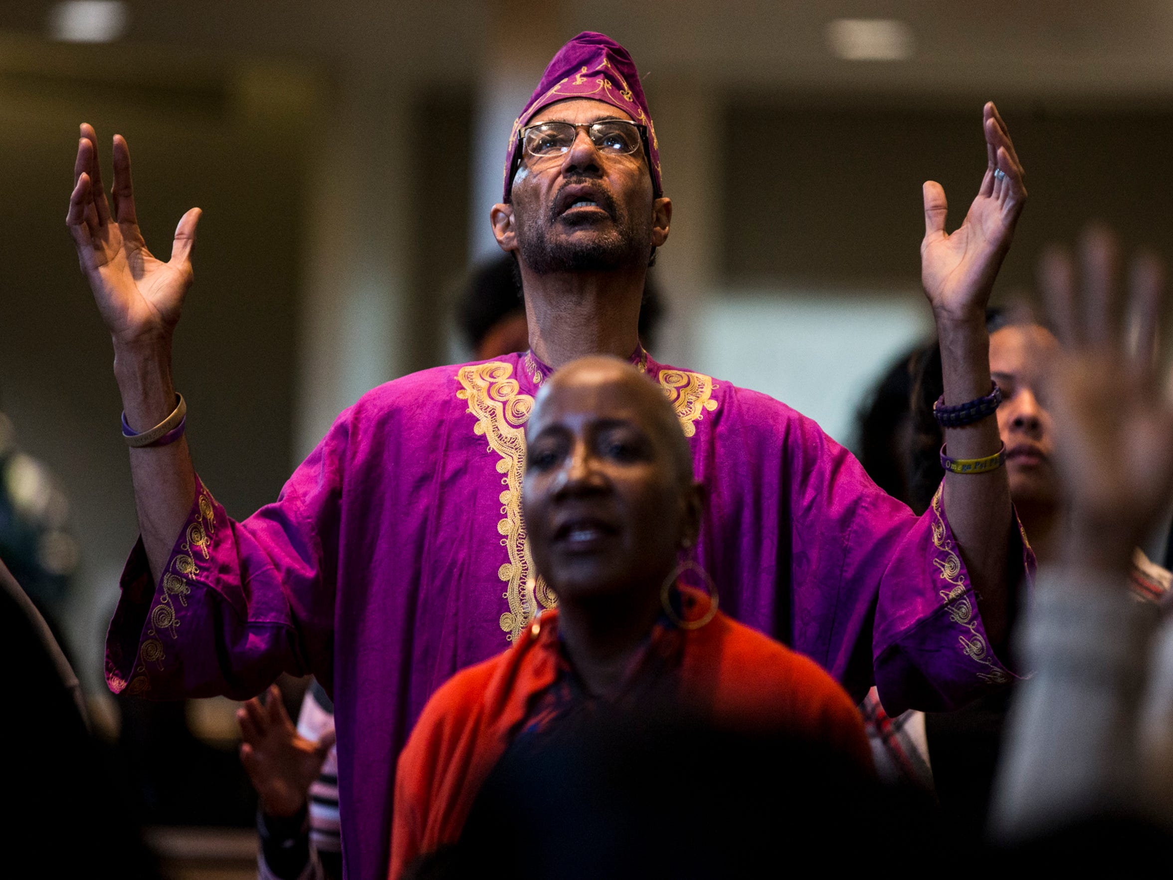 A congregant raises his arms during the 7:30 a.m. service on Feb. 24, 2019, at Pilgrim Rest Baptist Church in Phoenix.