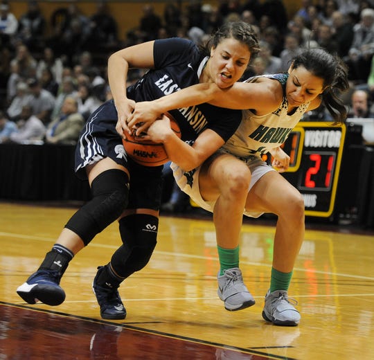 Michigan State-bound Moira Joiner (4), right, leads Saginaw Heritage.