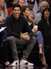 Christian Yelich of the Milwaukee Brewers watches the Bucks game on Monday night.