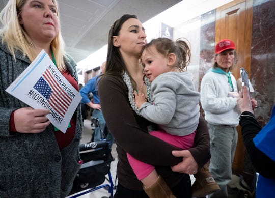 Sarah Myriam of New Jersey holds her two-year-old daughter Aliyah, joining activists opposed to vaccinations before a Senate Committee hearing on health, education, work and pensions on vaccine safety. Is held on March 5, 2019.