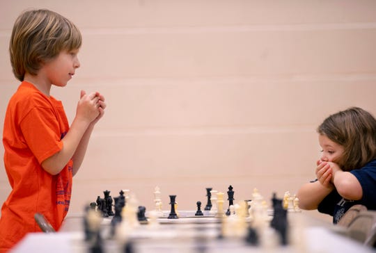 Cristian Diaz, 8, McCutchanville Elementary School, left, and Ana Schmitt, 7, Oak Hill Elementary School, wind up in a stalemate at the K-12 Spring Scholastic Chess Tournament at North Junior High School Saturday.