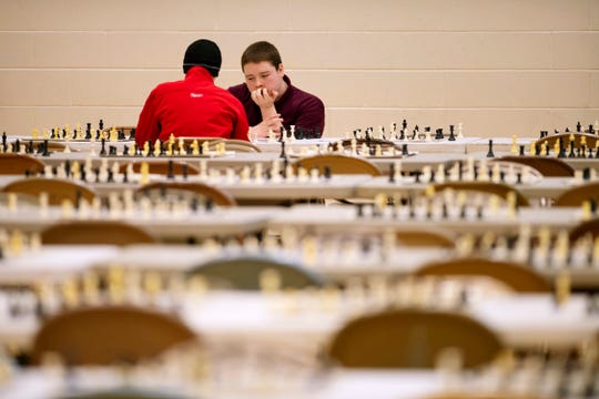 Henry Adams, 15, Mount Vernon High School, left, and Gary Richardson, 17, Central High School, compete in the K-12 Spring Scholastic Chess Tournament at North Junior High School Saturday.