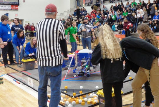 Dayton Innovator Robotics team 3311 and alliance members look on as their robot competes in a final qualifying round of the state championship tournamen at Loveland High School.