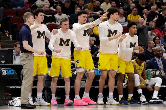 Michigan bench reacts during the first half against Iowa.