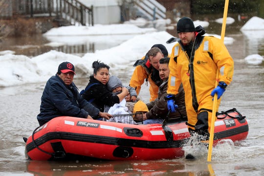 Firefighters in Green Bay are helping residents evacuate their homes due to the East River Flood on Friday, March 15, 2019 in Green Bay, Wisconsin. Heavy rains on frozen ground caused evacuations along the swollen rivers of Wisconsin, Nebraska and other Midwestern states, while powerful wind and snow hit hundreds of kilometers of rain. highway in North Dakota. (Adam Wesley / The Post-Crescent via AP) ORG XMIT: WIAPP505