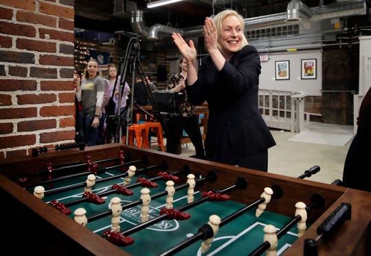 Democratic presidential candidate Sen. Kirsten Gillibrand celebrates her foosball victory at a campaign meet-and-greet on March 15, 2019, at To Share Brewing in Manchester, N.H.