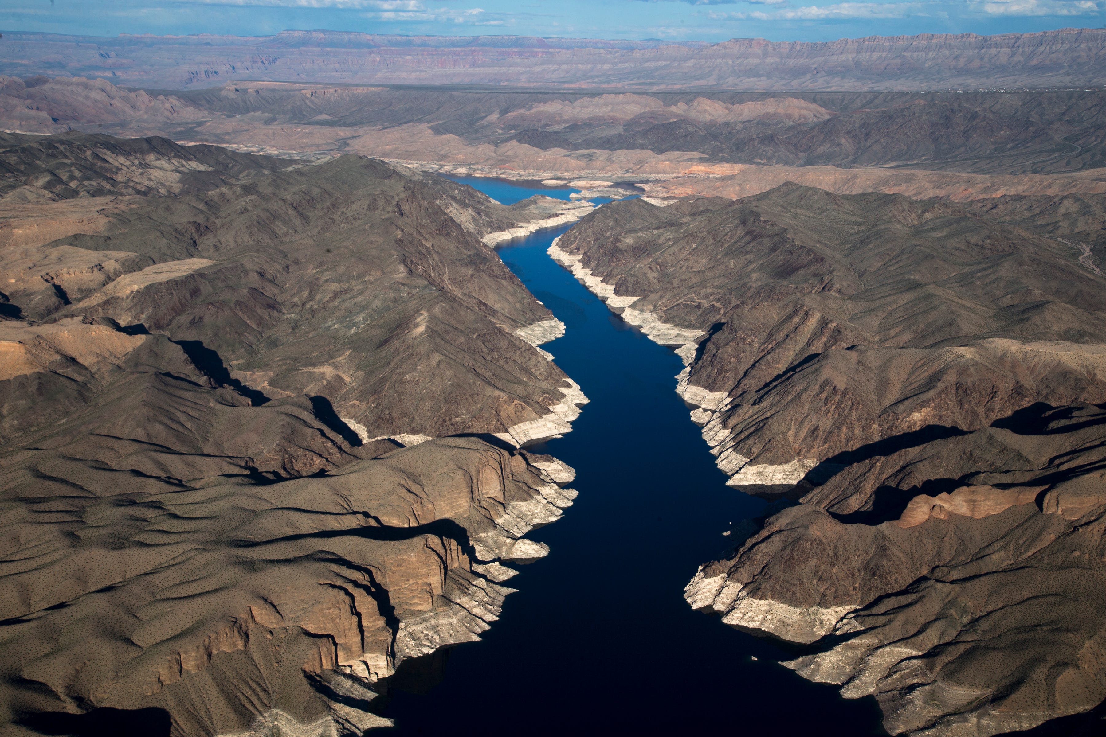 Lake Mead shows the effects of a prolonged drought, which has reduced the flow of the Colorado River. The high-water mark, or white bathtub ring, shows how far water levels have fallen.
