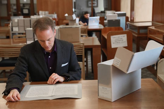 The archivist Bill Fliss examines some of the manuscripts from the extensive J.R.R. collection of Marquette University. Tolkien Archives. Marquette has notes, manuscripts and early drafts of "The Hobbit", "The Lord of the Rings" and other works by Tolkien. Fliss started collecting oral stories from Tolkien fans.