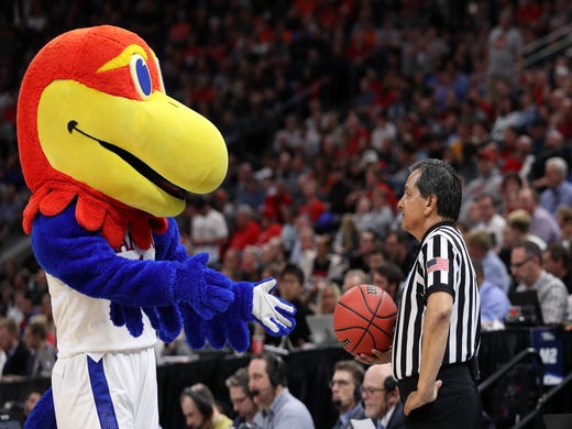 First round: The Kansas Jayhawks mascot interacts with a referee during the game against the Northeastern Huskies.