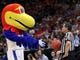 First round: The Kansas Jayhawks mascot interacts with a referee during the game against the Northeastern Huskies.