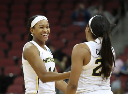 Michigan's Akienreh Johnson, left, and Deja Church celebrate after the Wolverines went on a run forcing Kansas State to call a timeout in the first round of the women's NCAA tournament in Louisville on March 22, 2019.