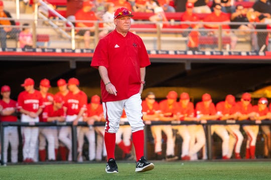 Cajuns coach Tony Robichaux walks to first base to talk to his player during a game against Appalachian State on March 22, 2019.
