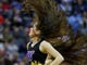 First round: A Washington Huskies cheerleader performs during the game against the Utah State Aggies.