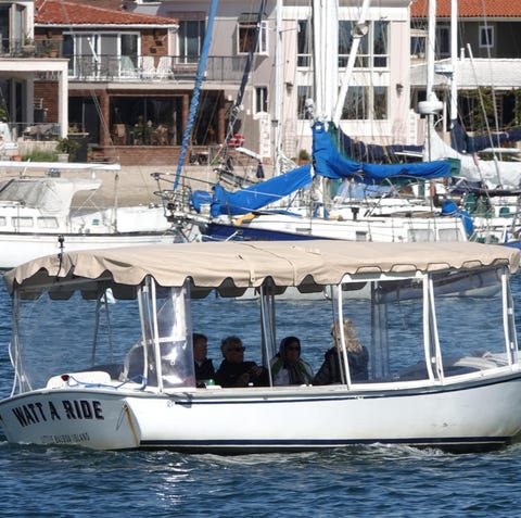 The electric Duffy boats line the Newport Beach...