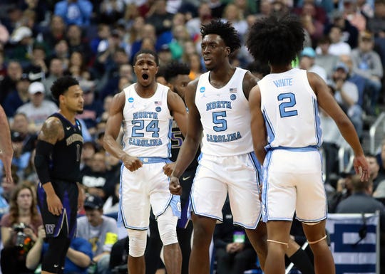 North Carolina Tar Heels guard Kenny Williams (24) celebrates with forward Nassir Little (5) and guard Coby White (2) against the Washington Huskies in the second round of the 2019 NCAA Tournament at Nationwide Arena.