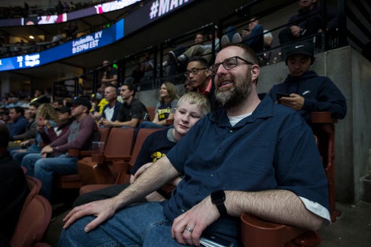 Michigan fan Gregg Nigl and his son Kaiden Nigl, 9, both of Columbus, Ohio, watch the Gonzaga-Florida State game at the Honda Center in Anaheim, Calif., Thursday, March 28, 2019. Gregg Nigl is the first person to correctly pick every winner in the first two rounds of the NCAA tournament.